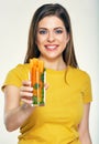 Young smiling woman holding glass with carrot. Royalty Free Stock Photo