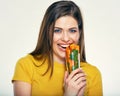 Young smiling woman holding glass with carrot. Royalty Free Stock Photo