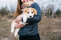 Young woman holding her Corgi puppy outdoors Royalty Free Stock Photo