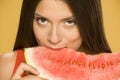 Young smiling woman holding a piece of watermelon Royalty Free Stock Photo