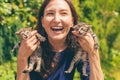 Young smiling woman holding two little kittens in her hands