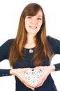 Young smiling woman holding white ornate heart