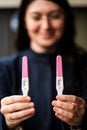 Young smiling woman with home pregnancy tests Royalty Free Stock Photo