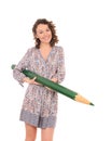 Young smiling woman with huge green pencil Royalty Free Stock Photo