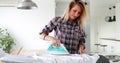 Young Smiling Woman Ironing Clothes On Ironing Board Royalty Free Stock Photo