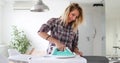 Young Smiling Woman Ironing Clothes On Ironing Board Royalty Free Stock Photo