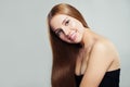 Young smiling woman with long shiny healthy brown hair on white background. Haircare concept Royalty Free Stock Photo