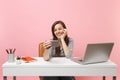 Young smiling woman making video call doing taking selfie shot on mobile phone while sit work at white desk with pc Royalty Free Stock Photo