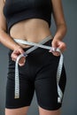 smiling woman measures her ideal waist with a tape measure and shows the result of her diet. Royalty Free Stock Photo