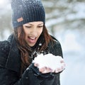 Young smiling woman playing with snow in winter park Royalty Free Stock Photo