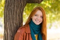 Young smiling woman posing near the tree in park Royalty Free Stock Photo