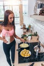 Young smiling woman preparing healthy breakfast. Diet, fitness and vitality.