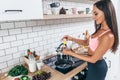 Young smiling woman preparing healthy breakfast. Diet, fitness and wellbeing.