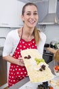 Young smiling woman presenting a plate of cheese. Royalty Free Stock Photo