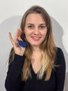 Young, smiling woman proudly holding two silver keys in her hands Royalty Free Stock Photo