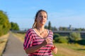 Young smiling woman running along river Royalty Free Stock Photo