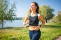 Young smiling woman running in park in the morning Royalty Free Stock Photo