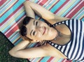 Young smiling woman in sailor outfit is lying on the retro blank Royalty Free Stock Photo