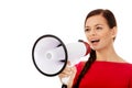 Young smiling woman screaming through a megaphone