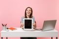 Young smiling woman showing on camera tablet computer with blank empty screen, sit work at white desk with contemporary Royalty Free Stock Photo