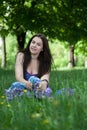 Young smiling woman sitting in the grass