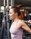 Young smiling woman squatting with barbell in gym Royalty Free Stock Photo