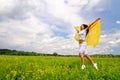 Young smiling woman standing with silk shawl in meadow Royalty Free Stock Photo