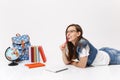 Young smiling woman student in glasses thinking gnawing and biting pencil lying near notebook, globe, backpack, school Royalty Free Stock Photo