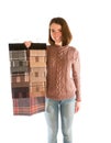 Young smiling woman in sweater holding fabric swatches Royalty Free Stock Photo