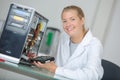 Young smiling woman technician repairs computer Royalty Free Stock Photo
