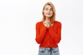 Young smiling woman thinking, daydreaming, standing happy against white background Royalty Free Stock Photo