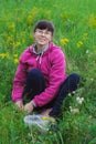 Young smiling woman to picking wild strawberries Royalty Free Stock Photo