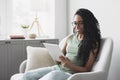 Young beautiful woman using digital tablet computer at home, Leisure, relaxation, online learning, web chat concept Royalty Free Stock Photo