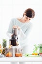 Woman using a juice extractor Royalty Free Stock Photo