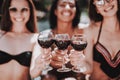 Young Smiling Women Drinking Wine at Poolside Royalty Free Stock Photo