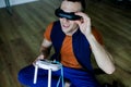 Young Man Wearing Virtual Reality. Man Playing Video Games Virtual Reality Glasses In His Apartment. Royalty Free Stock Photo