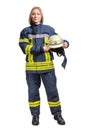 Young smilng firefighter woman in fireproof uniform stands and looks at the camera with a helmet in her hands