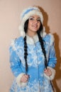 Young Snow Maiden. Sexy woman dressed in the traditional Russian New Year`s costume Snow Maiden, a girl in a blue New Year`s sui Royalty Free Stock Photo