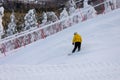 Young snowboarder boy snowboarding down the snowy slope. Winter Sports and Recreation Royalty Free Stock Photo