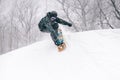 Young snowboarder drops into a half pipe