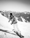 Young snowboarder ride downhill in scenic caucasus mountains in fast freeze motion steep downhill solo