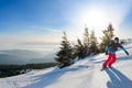 Young Snowboarder Riding Red Snowboard in Mountains at Sunny Day. Snowboarding and Winter Sports Royalty Free Stock Photo