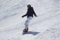Young snowboarder woman sliding downhill. Royalty Free Stock Photo