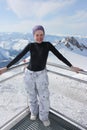 Young snowboarder woman on the top of the mountain. Royalty Free Stock Photo