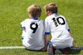 Young Soccer Football Players. Little Boys Sitting on Soccer Pitch