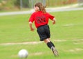 Young soccer player chasing ball