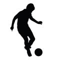 Young soccer player passes the ball silhouette