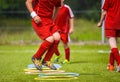 Young Soccer Player Practicing on the Pitch. Soccer Football Equpment. Dynamic Jumping Football Practice