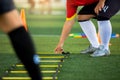 Young soccer player is putting the ladder drills for soccer trainng to run and jump Royalty Free Stock Photo