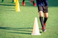 Young soccer player training with sport cone marker on green grass football pitch training ground Royalty Free Stock Photo